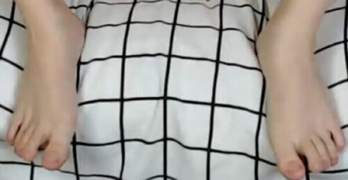 Feet on a grid-blanket surface Foot Fetish